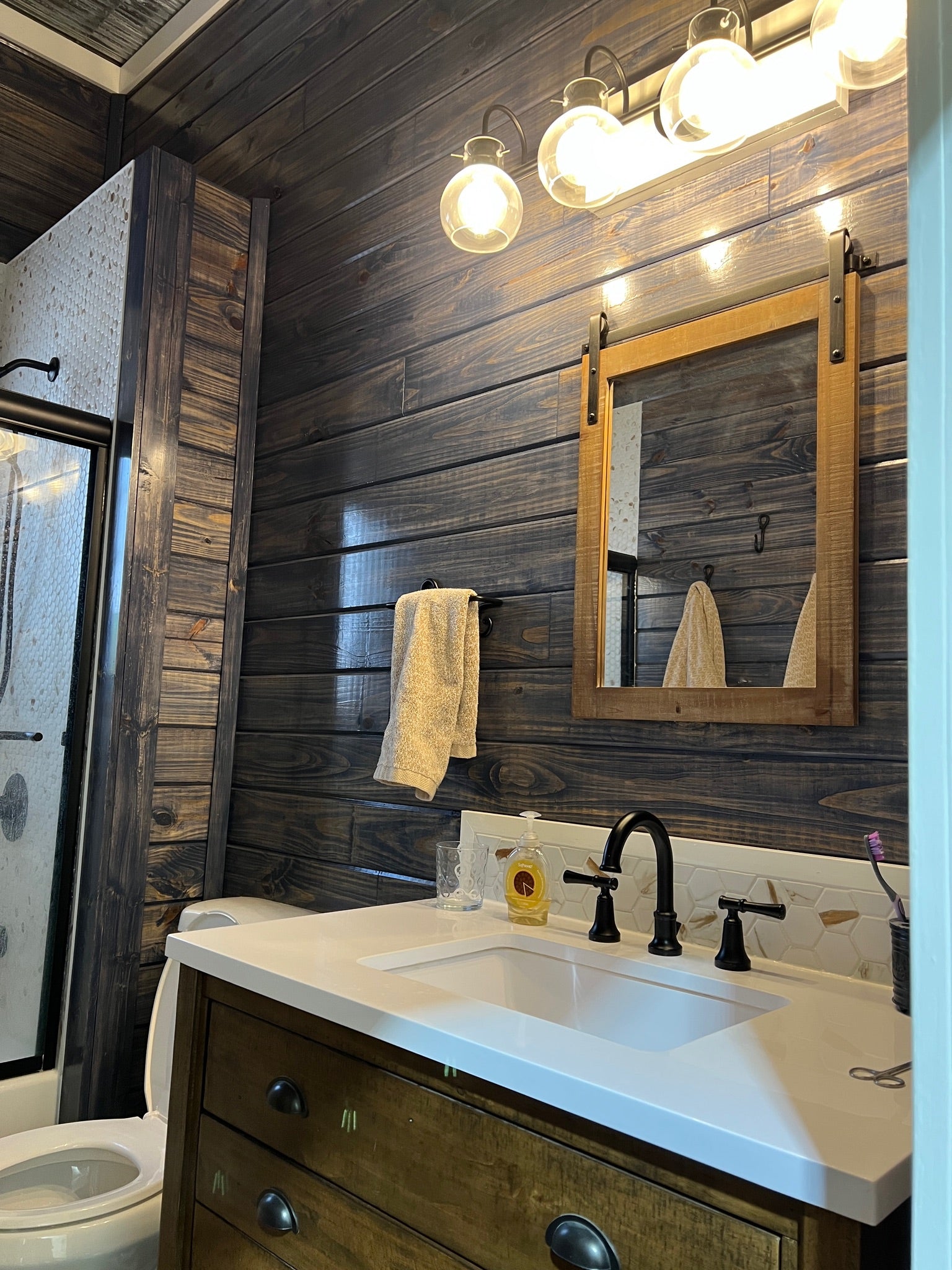 Pine T&G V-Groove Wall Panels Stained Dark in a Bathroom